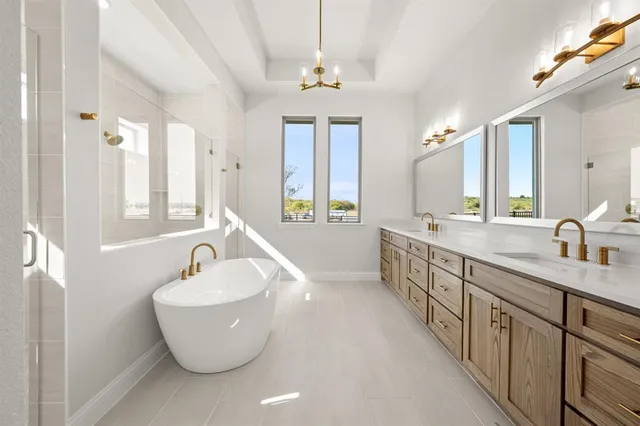 a large spacious bathroom with double vanity and a bathtub