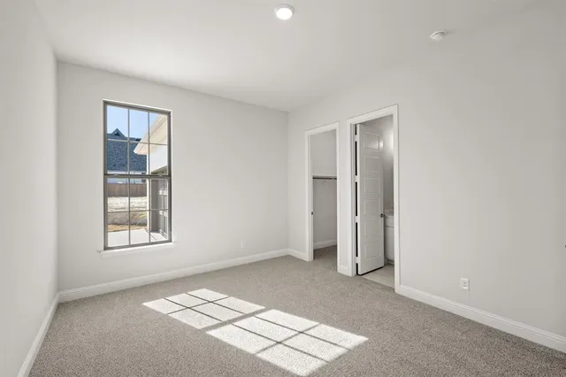 an empty room with windows and closet