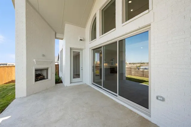 a view of a hallway with an entryway and livingroom