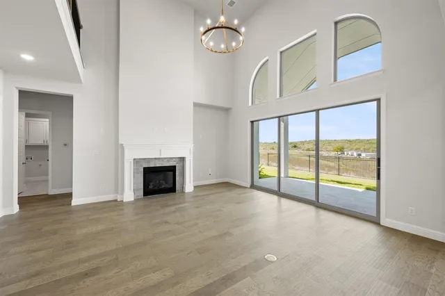 a view of an empty room with a fireplace and a window