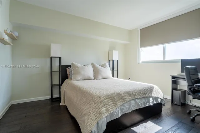 a bedroom with bed and a window