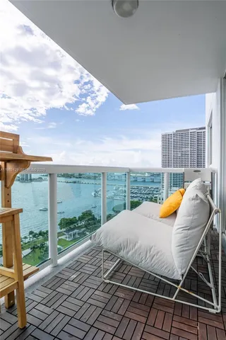 a balcony with a large trees and city view