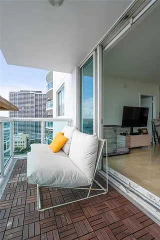 a bedroom with a bed and large windows