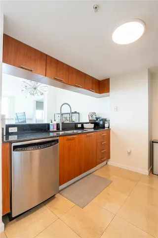 a kitchen with stainless steel appliances granite countertop a sink and cabinets