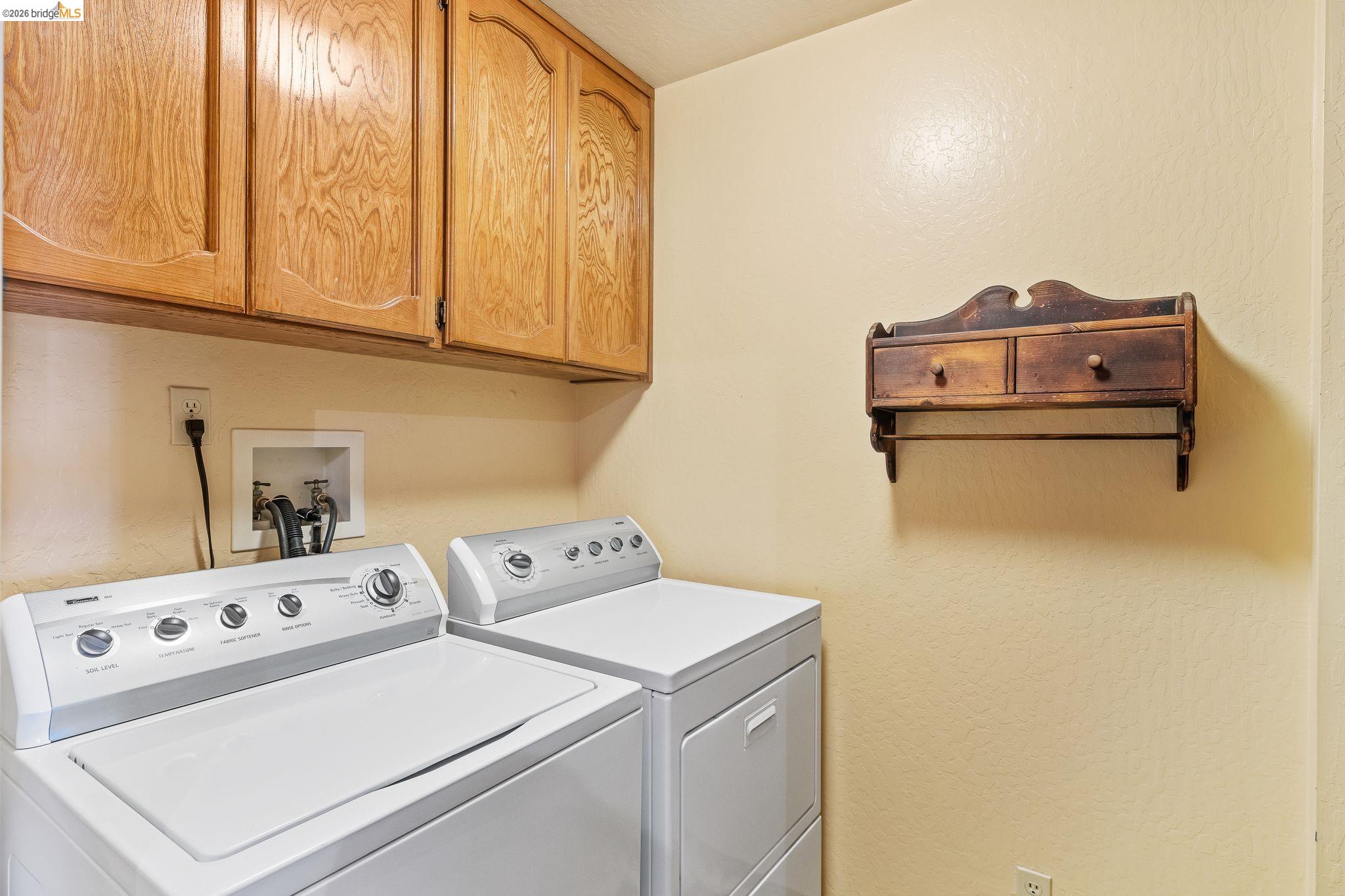 2051 Sand Point Road Discovery Bay, CA 94505 - Photo 22 of 47 Utility area featuring upper wood cabinetry and light-toned walls