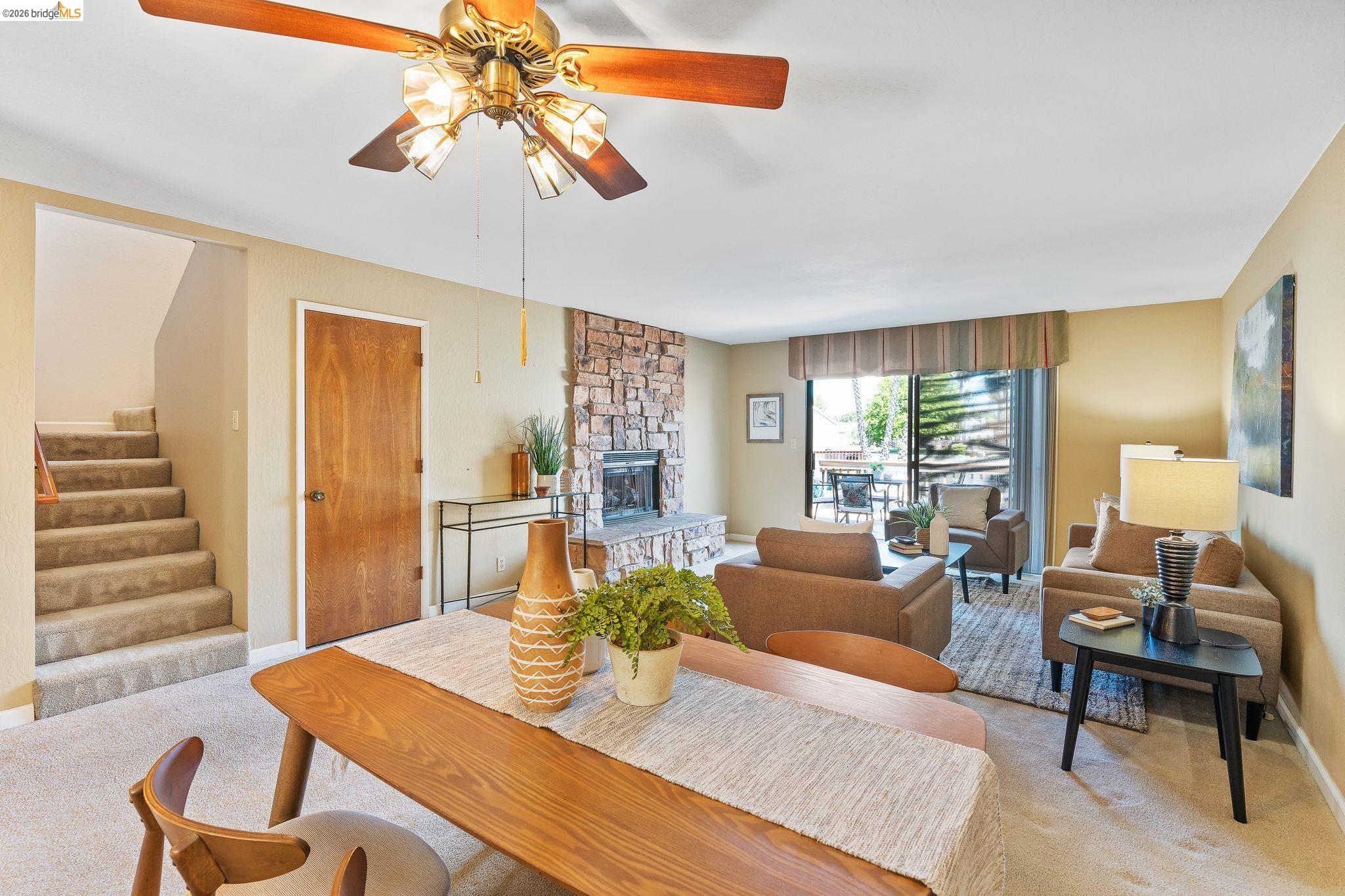 2051 Sand Point Road Discovery Bay, CA 94505 - Photo 23 of 47 Open living area featuring a stone-clad fireplace and sliding glass door access to an exterior space