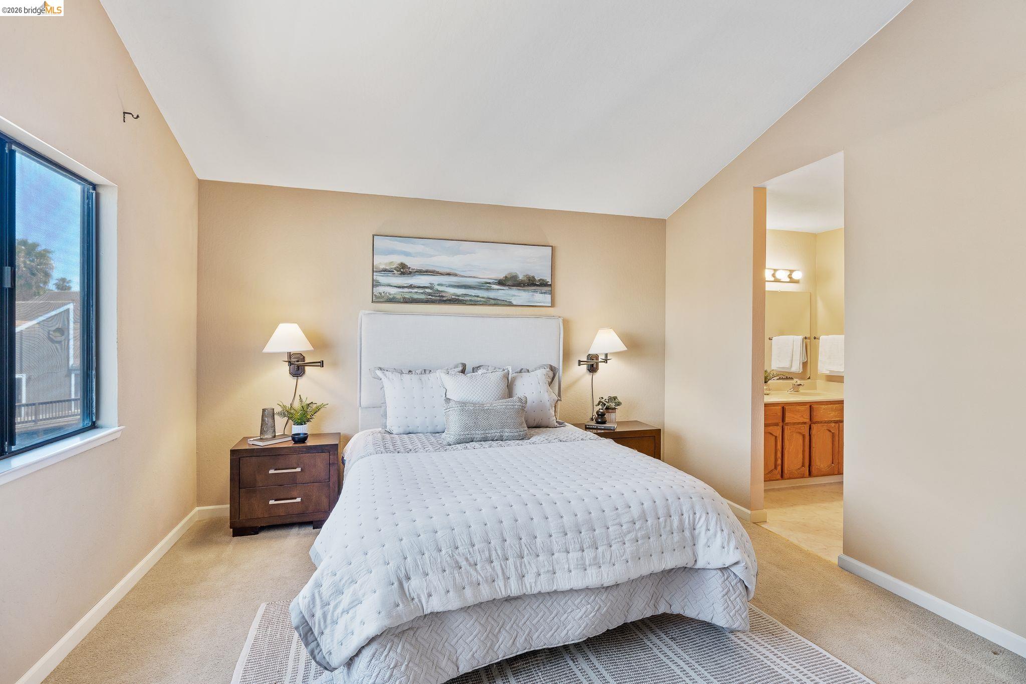 2051 Sand Point Road Discovery Bay, CA 94505 - Photo 25 of 47 Carpeted bedroom featuring a window, neutral wall paint, and a textured headboard