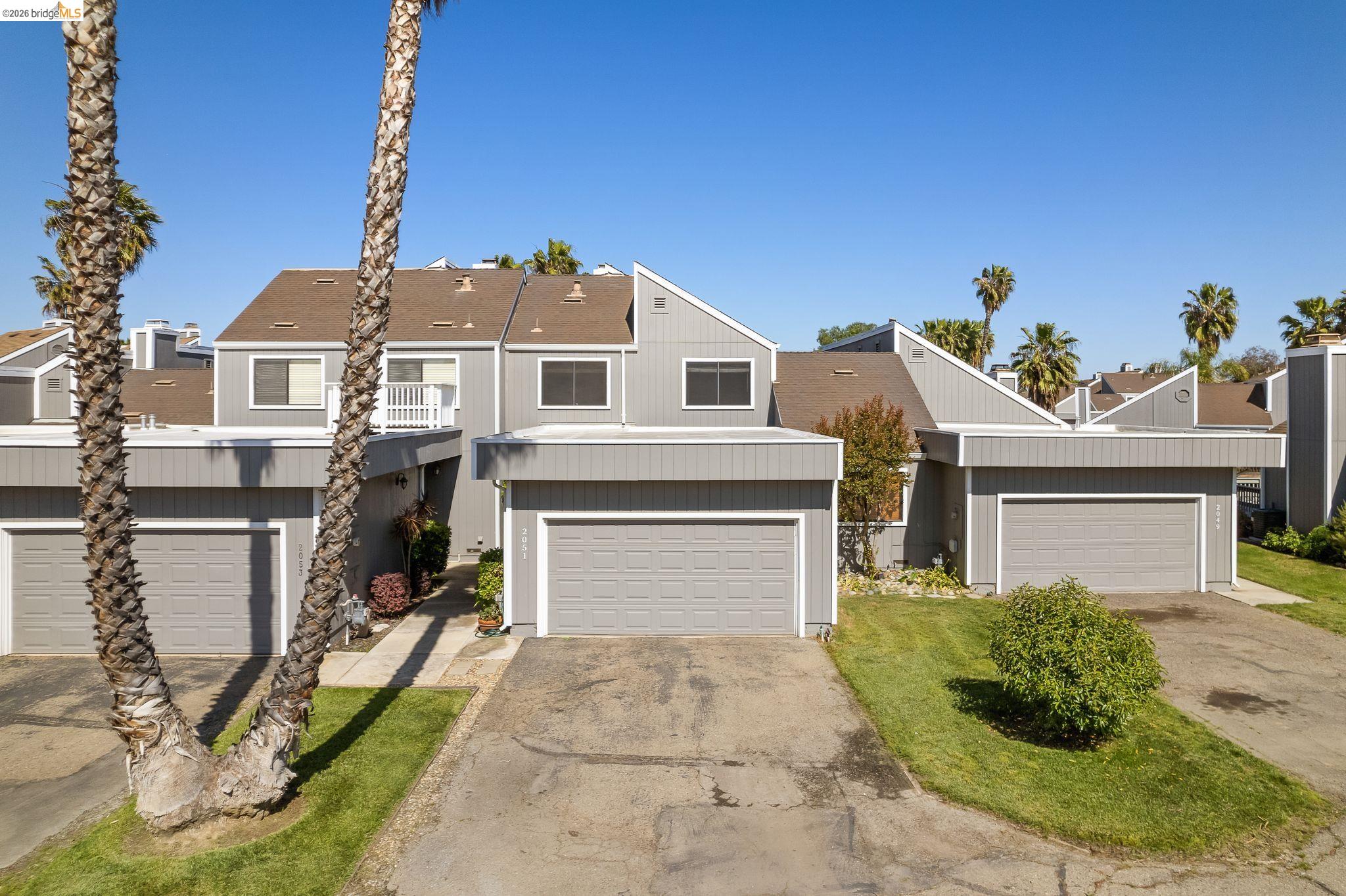 2051 Sand Point Road Discovery Bay, CA 94505 - Photo 3 of 47 Multi-level property featuring a gray exterior siding and a brown shingled roof