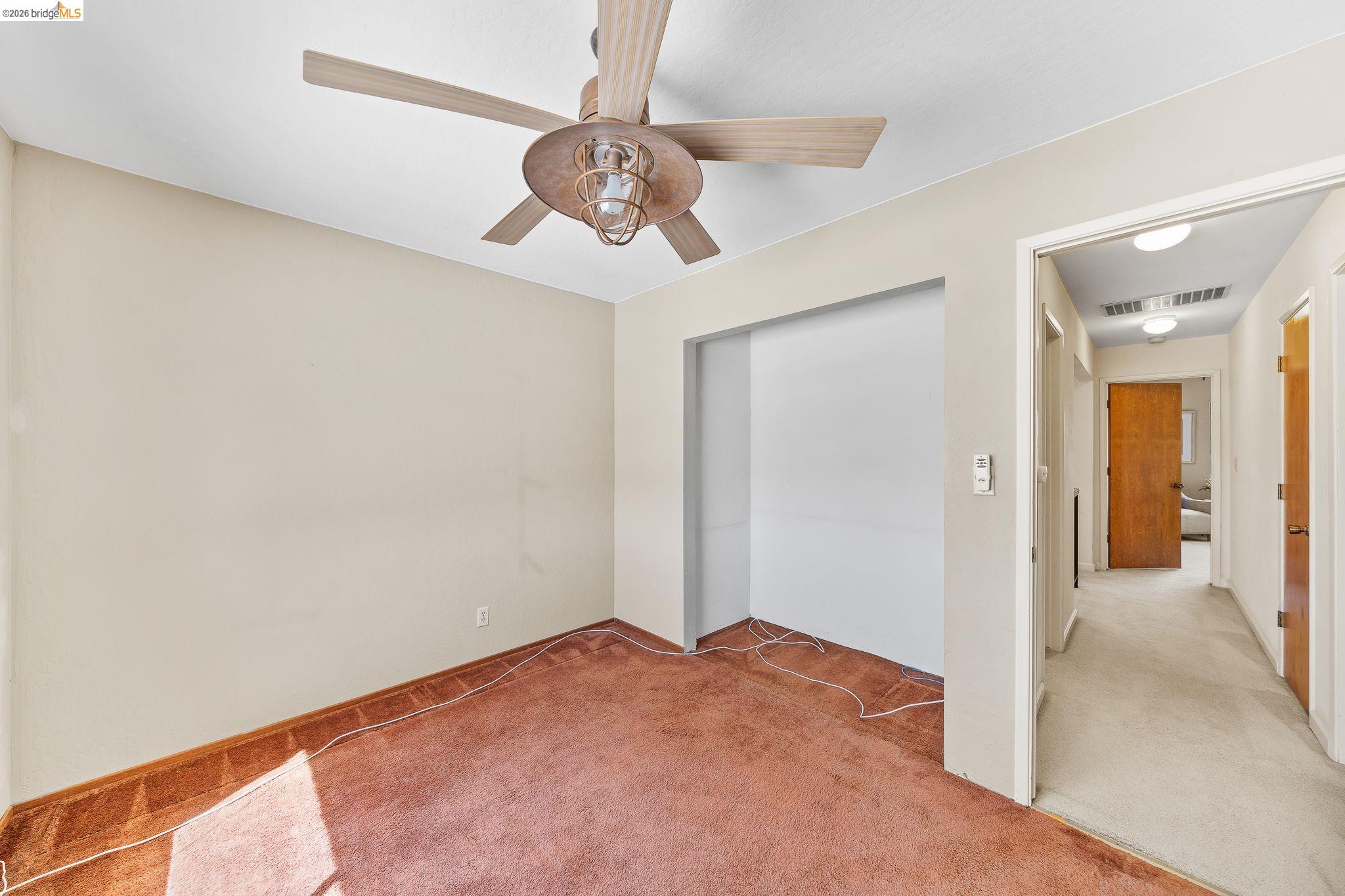 2051 Sand Point Road Discovery Bay, CA 94505 - Photo 36 of 47 Room featuring a ceiling fan with light fixture, neutral wall paint, and a recessed wall area