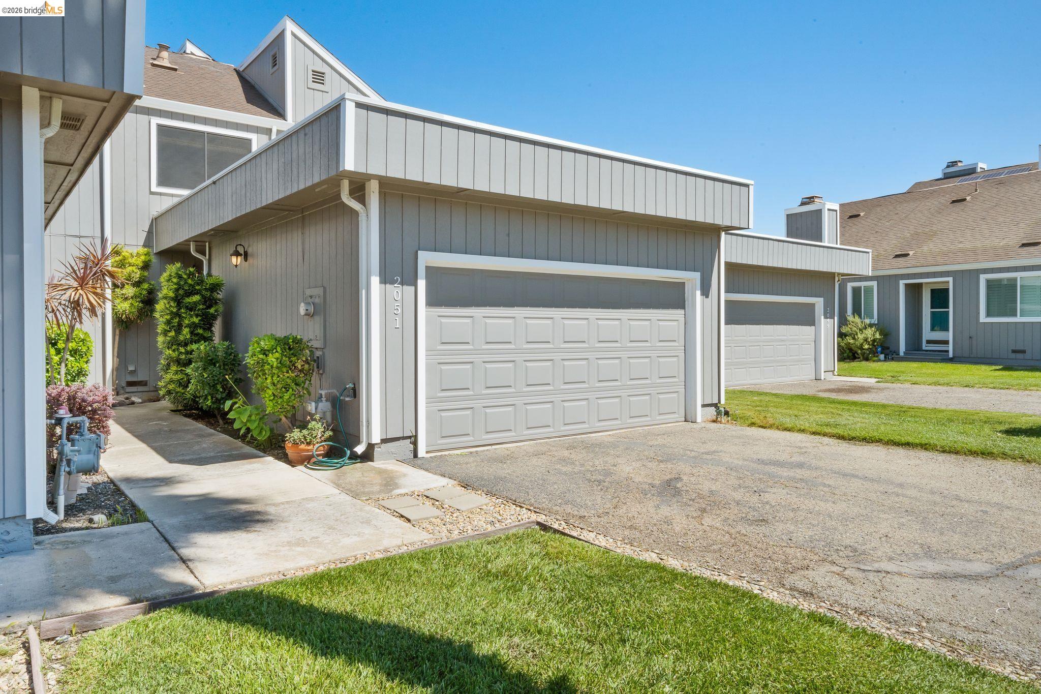 2051 Sand Point Road Discovery Bay, CA 94505 - Photo 5 of 47 Gray exterior with vertical siding and white trim