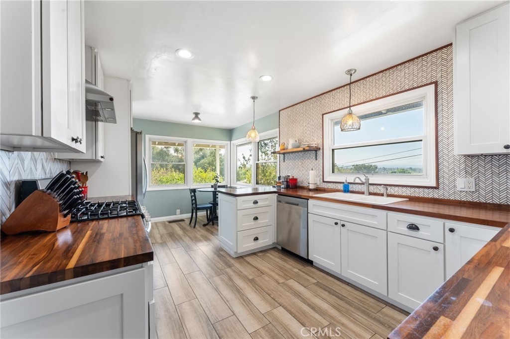4380 Miramonte Place Riverside, CA 92501 - Photo 16 of 73 a large white kitchen with sink and window