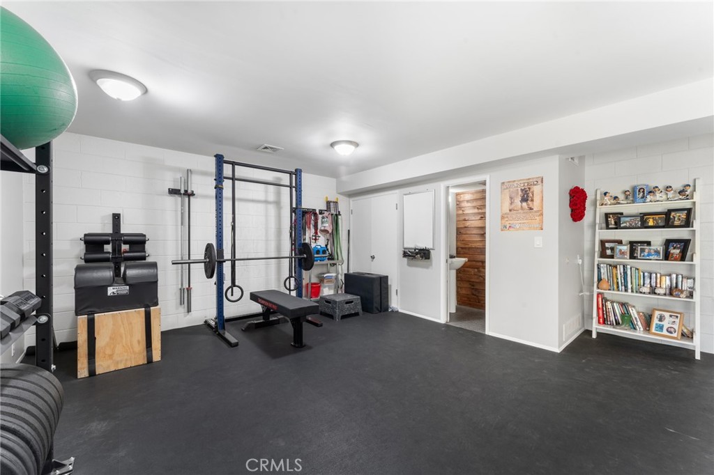 4380 Miramonte Place Riverside, CA 92501 - Photo 40 of 73 a living room with furniture gym equipment and a window