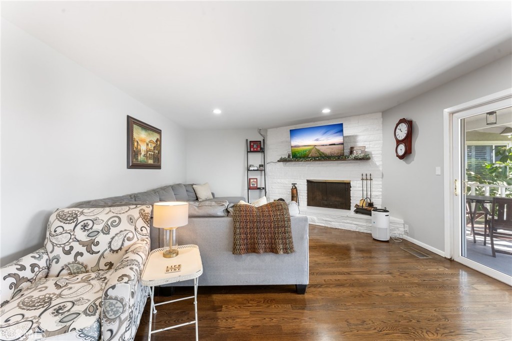 4380 Miramonte Place Riverside, CA 92501 - Photo 8 of 73 a living room with furniture a fireplace and a flat screen tv