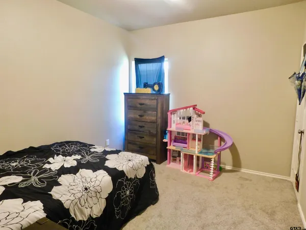 a bedroom with a bed and dresser