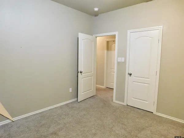 an empty room with closet area