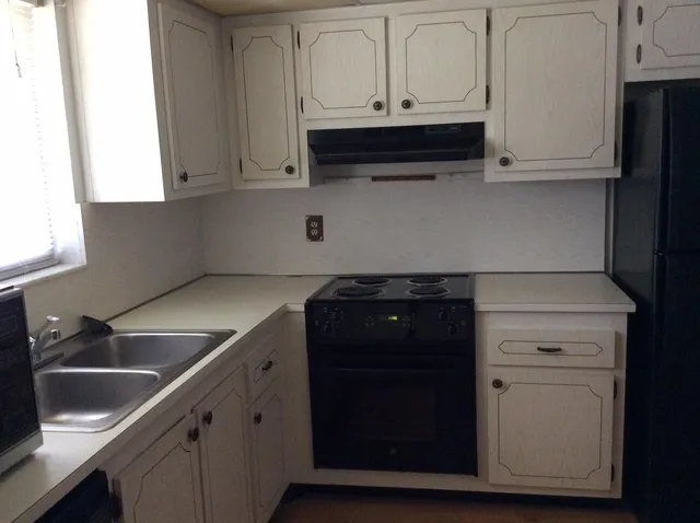 a kitchen with white cabinets and a sink