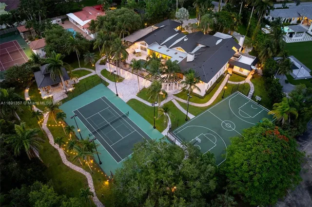 an aerial view of a house with a yard and outdoor seating