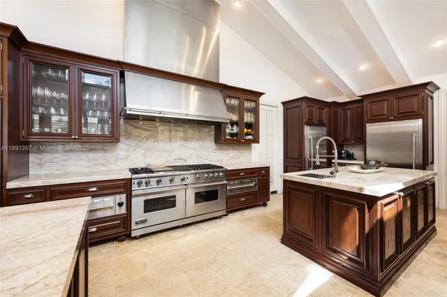 a kitchen with stainless steel appliances granite countertop a stove and a sink