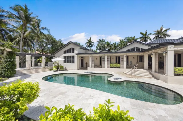 a front view of house with yard swimming pool and green space