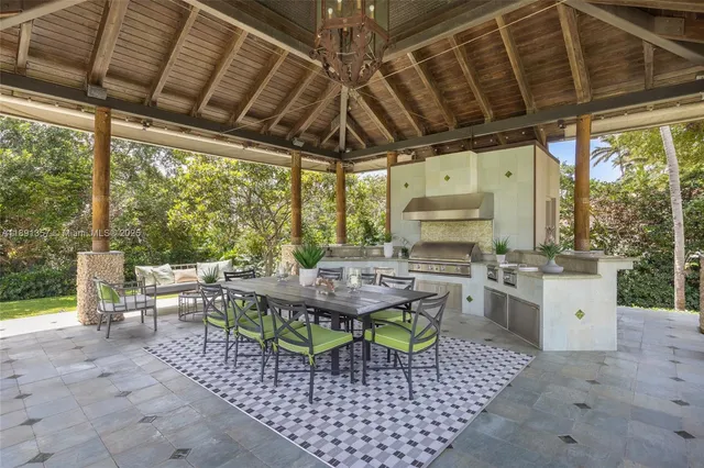 a outdoor space with the couches a dining table and chairs with outer view