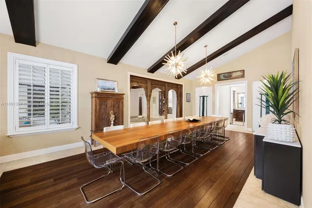 a dining room with wooden floor and window
