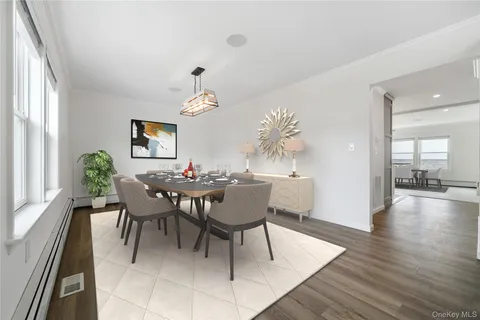 a dining room with furniture a window and wooden floor