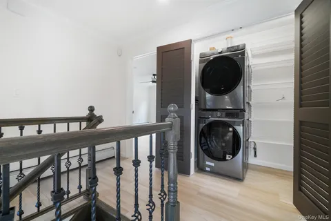 a view of a hallway with washer and dryer