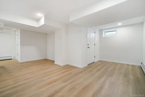 a view of an empty room and wooden floor