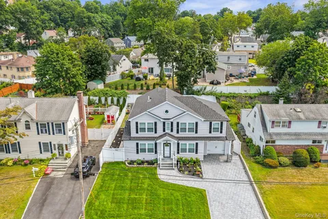 an aerial view of multiple houses with a yard