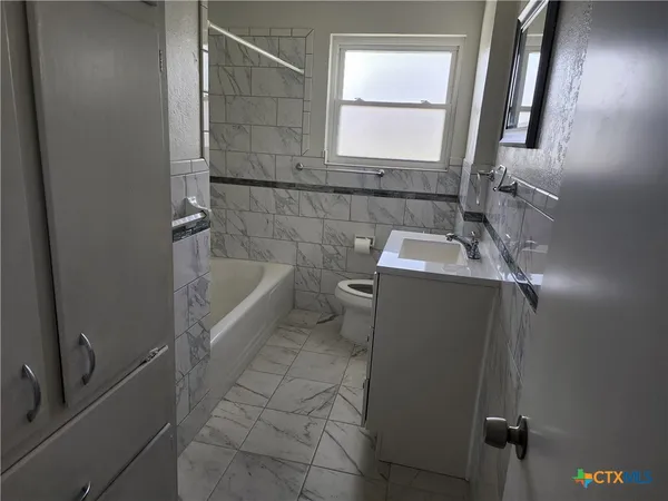 a bathroom with a sink toilet and tub