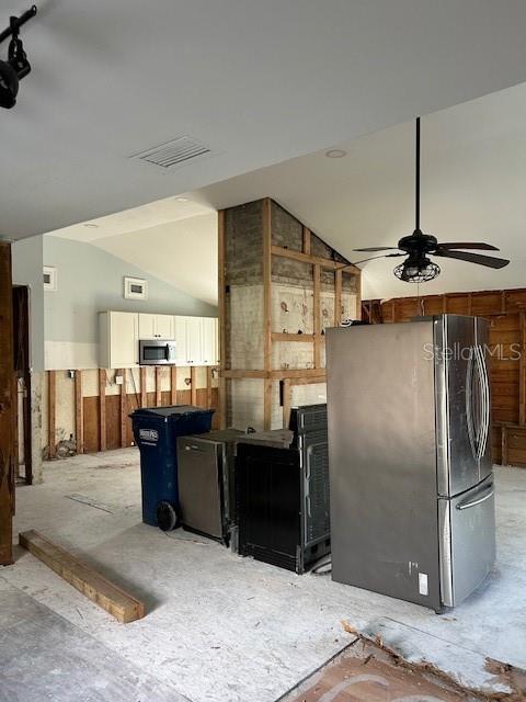 15416 2nd Street East Madeira Beach, FL 33708 - Photo 12 of 16 a kitchen with stainless steel appliances kitchen island granite countertop a refrigerator and a sink