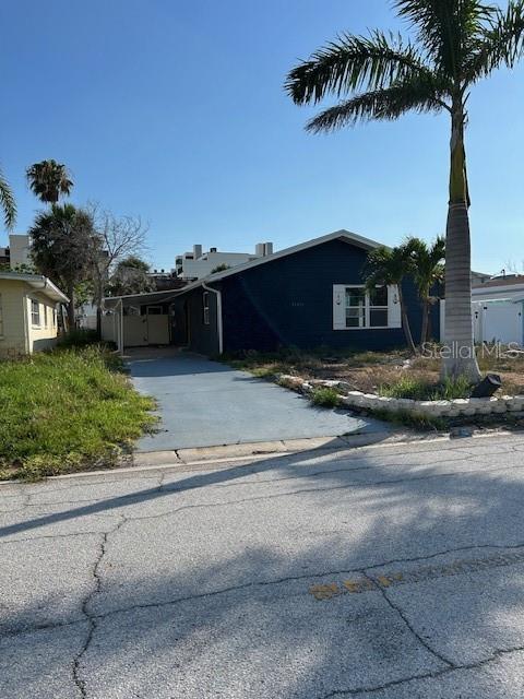 15416 2nd Street East Madeira Beach, FL 33708 - Photo 15 of 16 a front view of a house with garden
