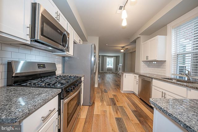 a kitchen with stainless steel appliances granite countertop a stove and a sink