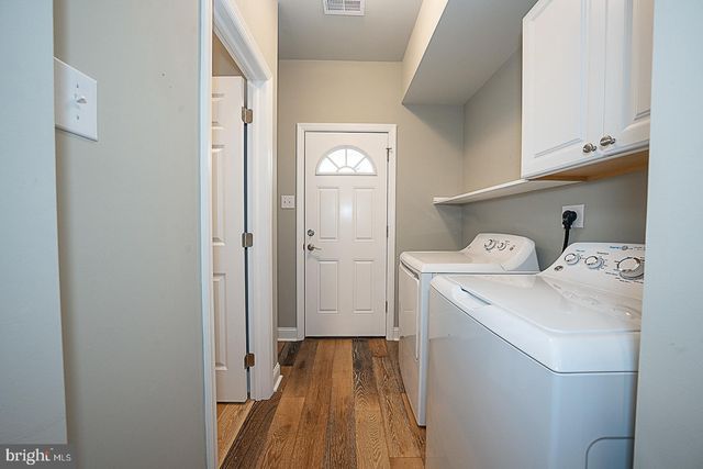 a view of a storage and utility room with a washer dryer