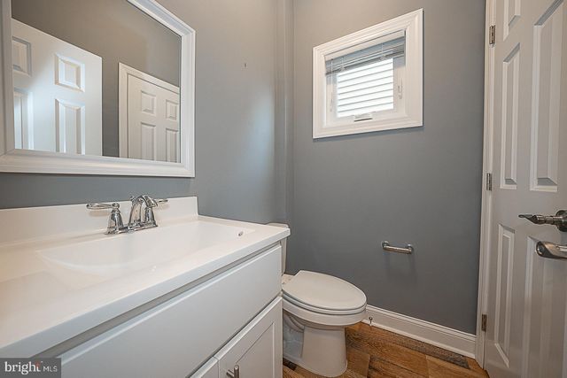 a white toilet sitting next to a bathroom sink