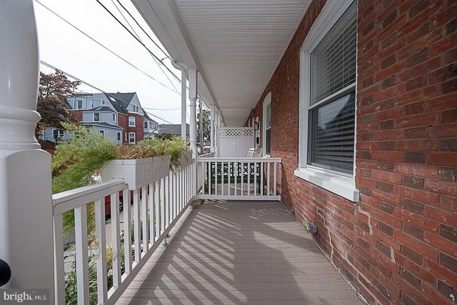 a view of a brick house stairs and wooden floor