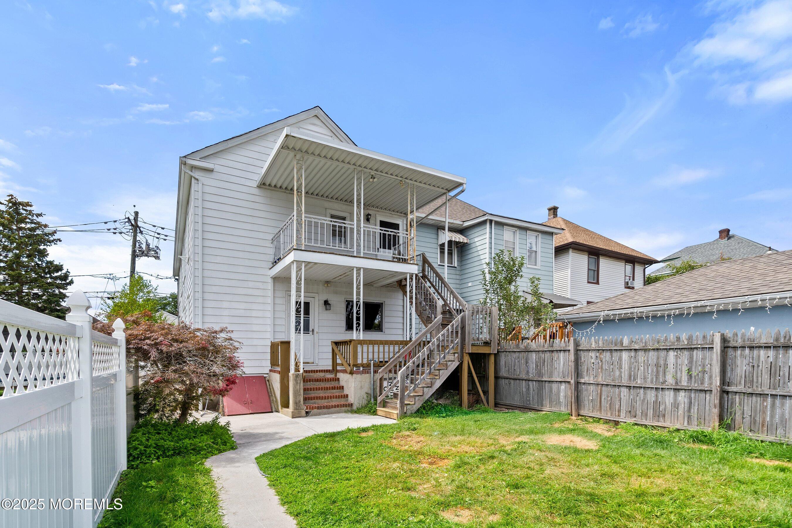 56 Ford Avenue, Unit 2 Fords, NJ 08863 - Photo 18 of 22 a view of a house with a small yard and a large tree