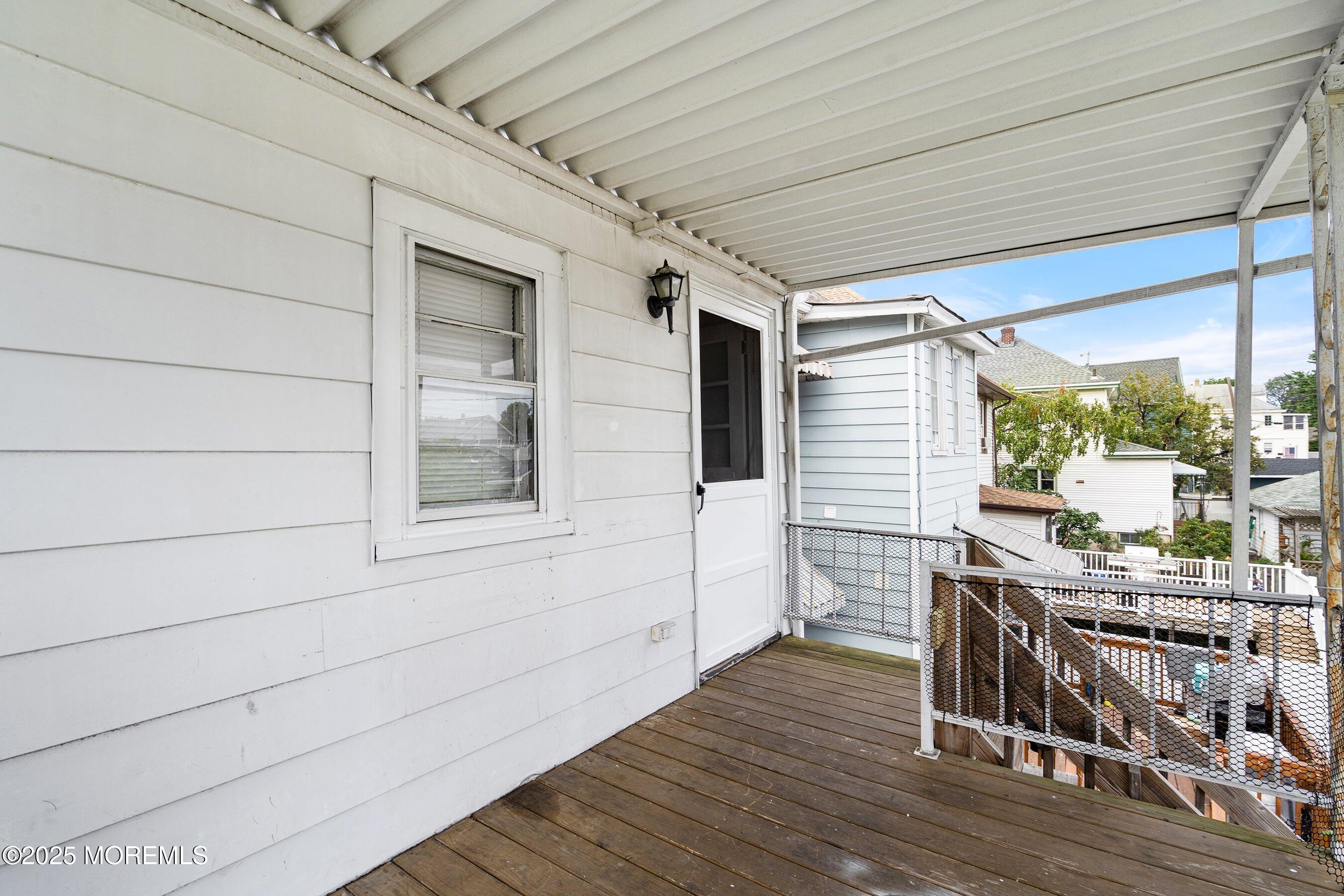 56 Ford Avenue, Unit 2 Fords, NJ 08863 - Photo 3 of 22 a balcony with table and chairs