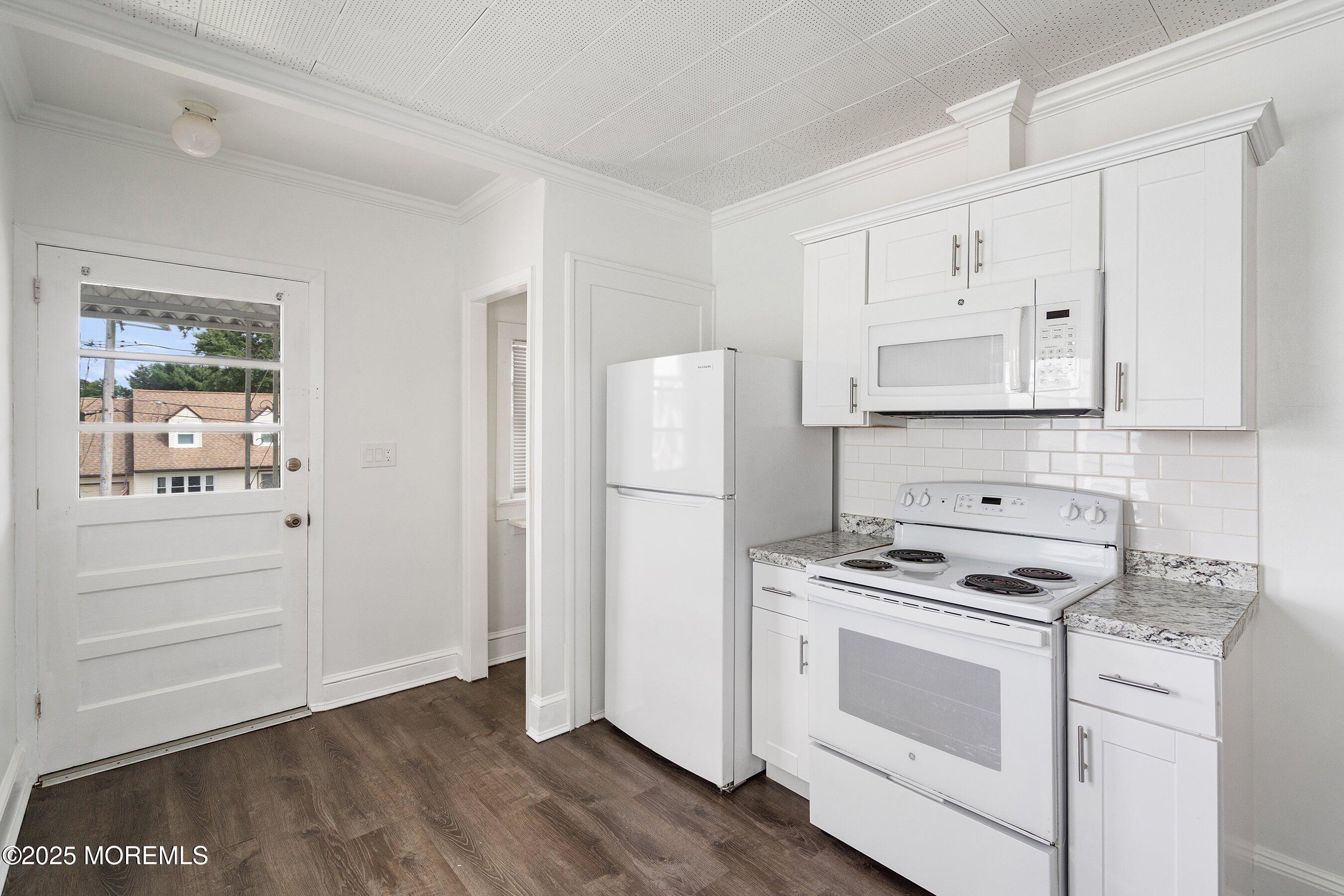 56 Ford Avenue, Unit 2 Fords, NJ 08863 - Photo 5 of 22 a kitchen with white cabinets and white appliances