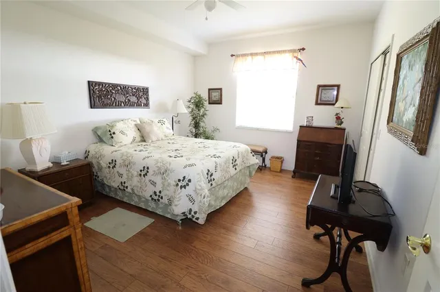 a bedroom with a bed and wooden floor