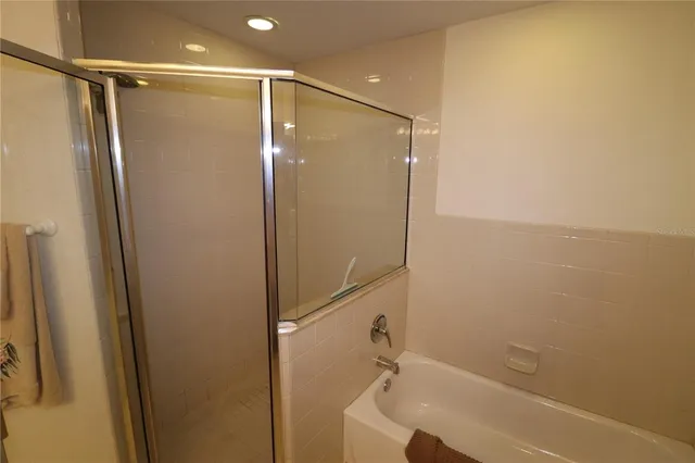 a bathroom with a shower and a glass door