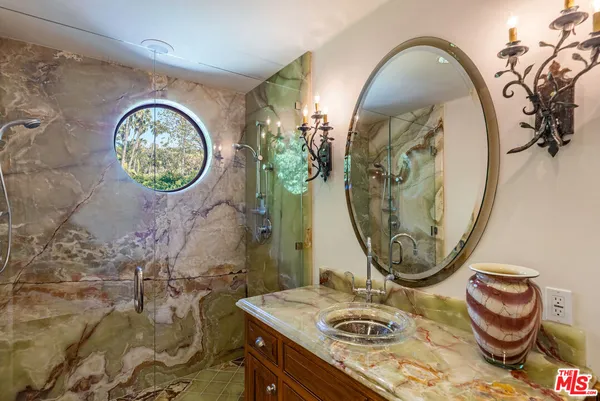 a bedroom with a bed and a view of balcony