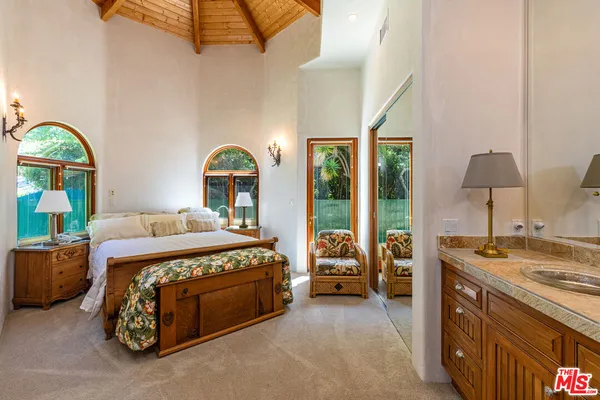a bathroom with a sink mirror and shower