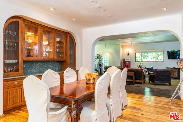 a dining room with furniture and wooden floor