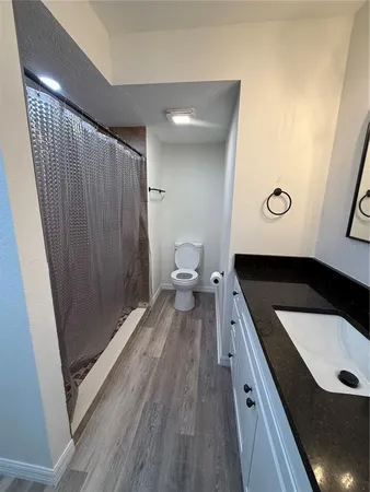 a bathroom with a toilet a sink and mirror