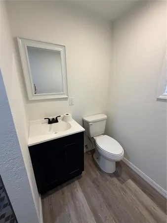 a bathroom with a toilet a sink and mirror