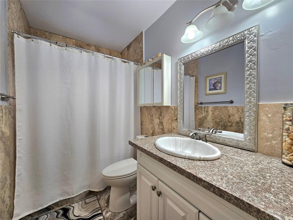 2141 Northeast 1st Court, Unit 201 Boynton Beach, FL 33435 - Photo 13 of 26 a bathroom with a granite countertop sink and a mirror