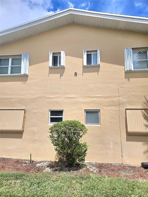 2141 Northeast 1st Court, Unit 201 Boynton Beach, FL 33435 - Photo 15 of 26 a front view of a house with plants