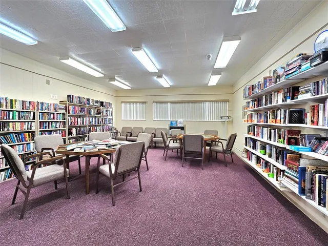 a view of a livingroom with furniture and a bookshelf