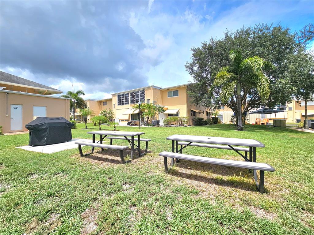 2141 Northeast 1st Court, Unit 201 Boynton Beach, FL 33435 - Photo 25 of 26 a view of a garden with sitting area
